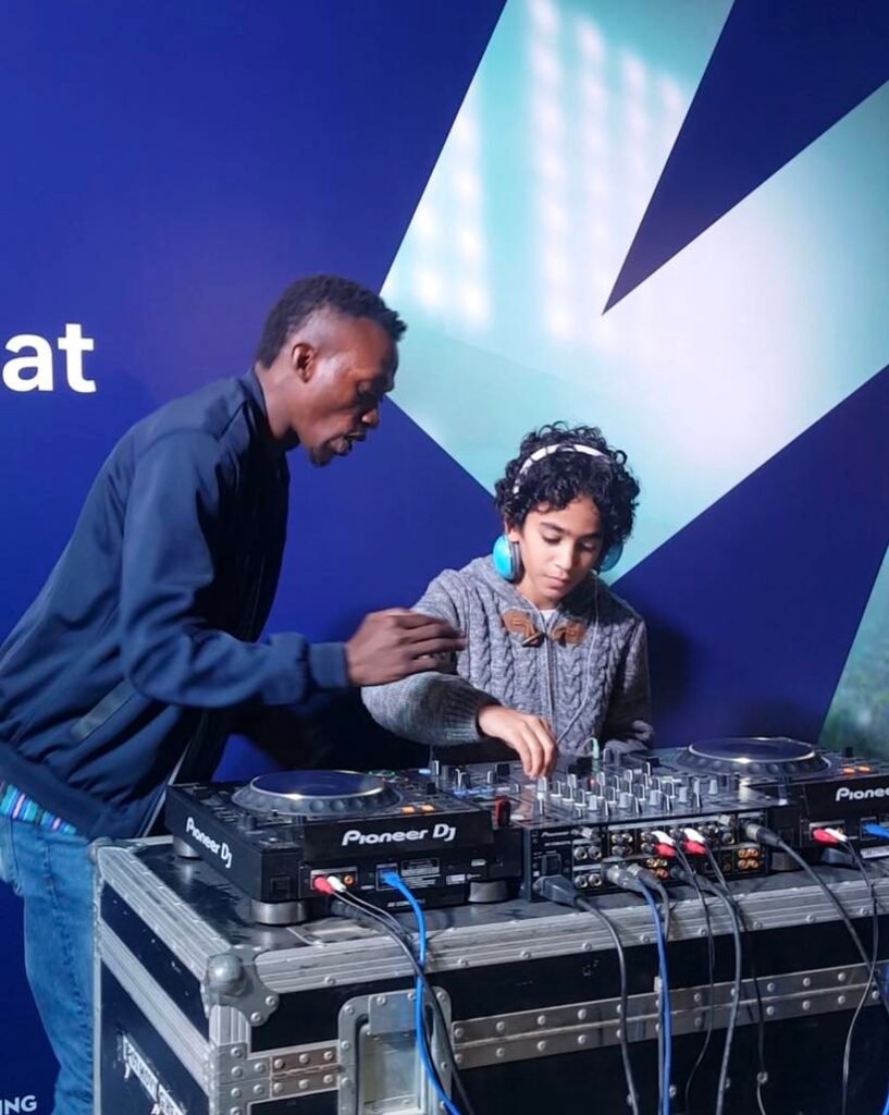 Dj Wasswa teaching kids how to Dj at a charity event in Dubai